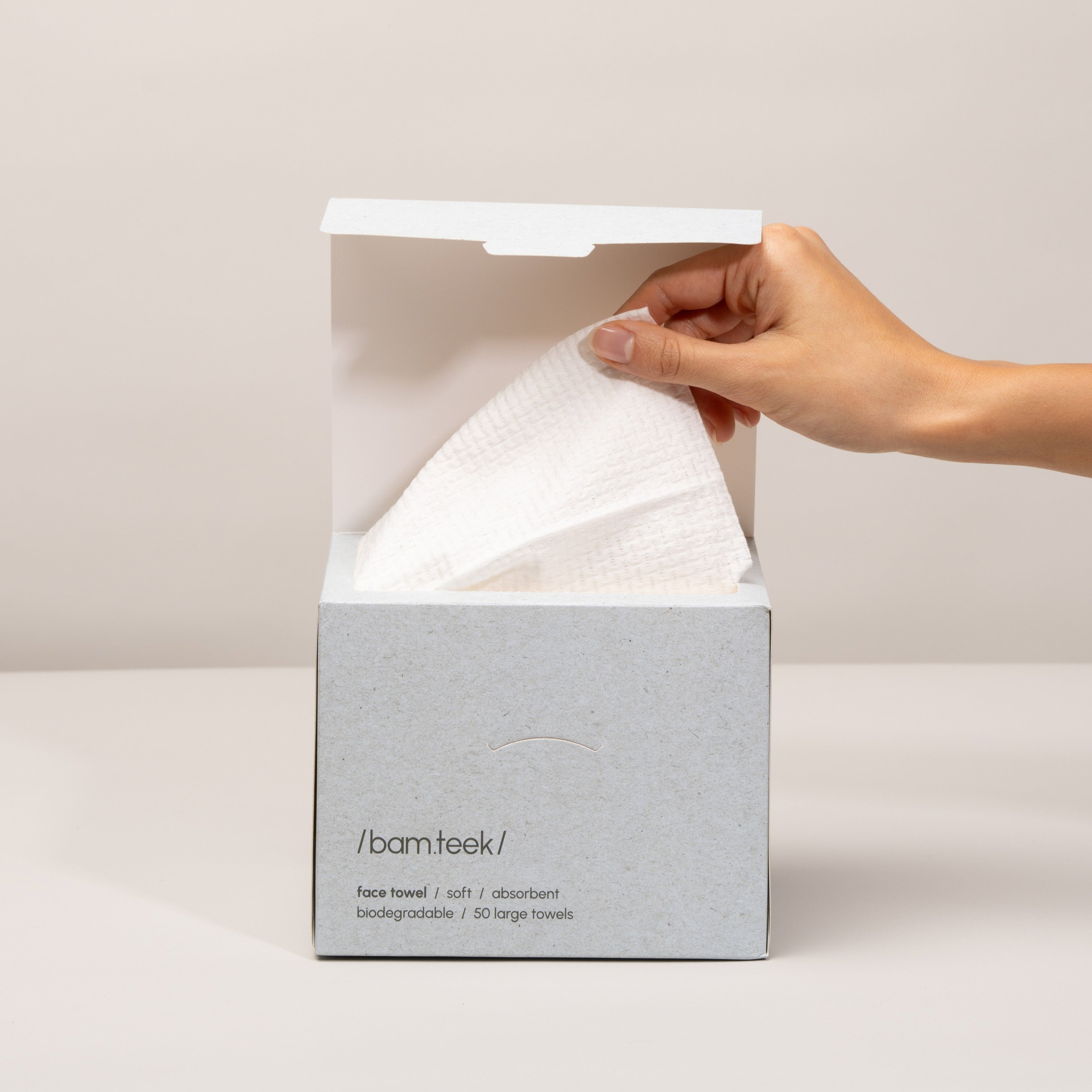 Person holding the Bamteek Face Pack of biodegradable face towels for clean skincare.
