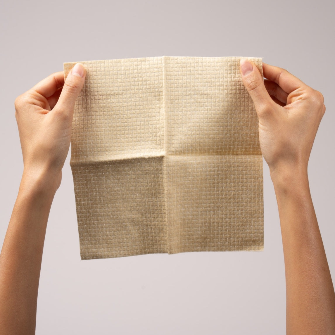 Kuwaiti Hands holding a soft, absorbent towel from the Golden Travel Bundle, made from 100% bamboo fibers.