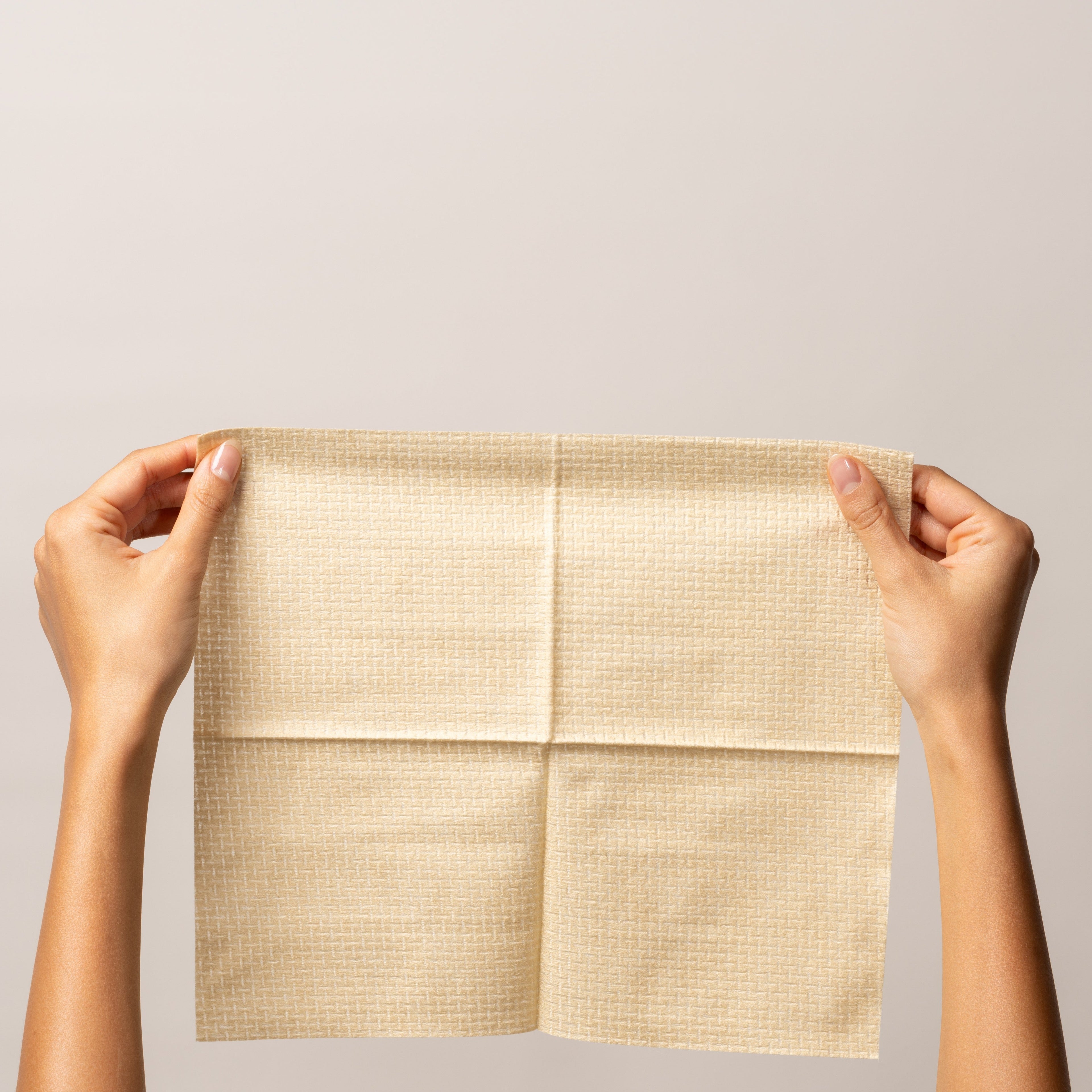 Golden Pack displayed in hands, showcasing the ultra-soft bamboo towel for sensitive skincare.