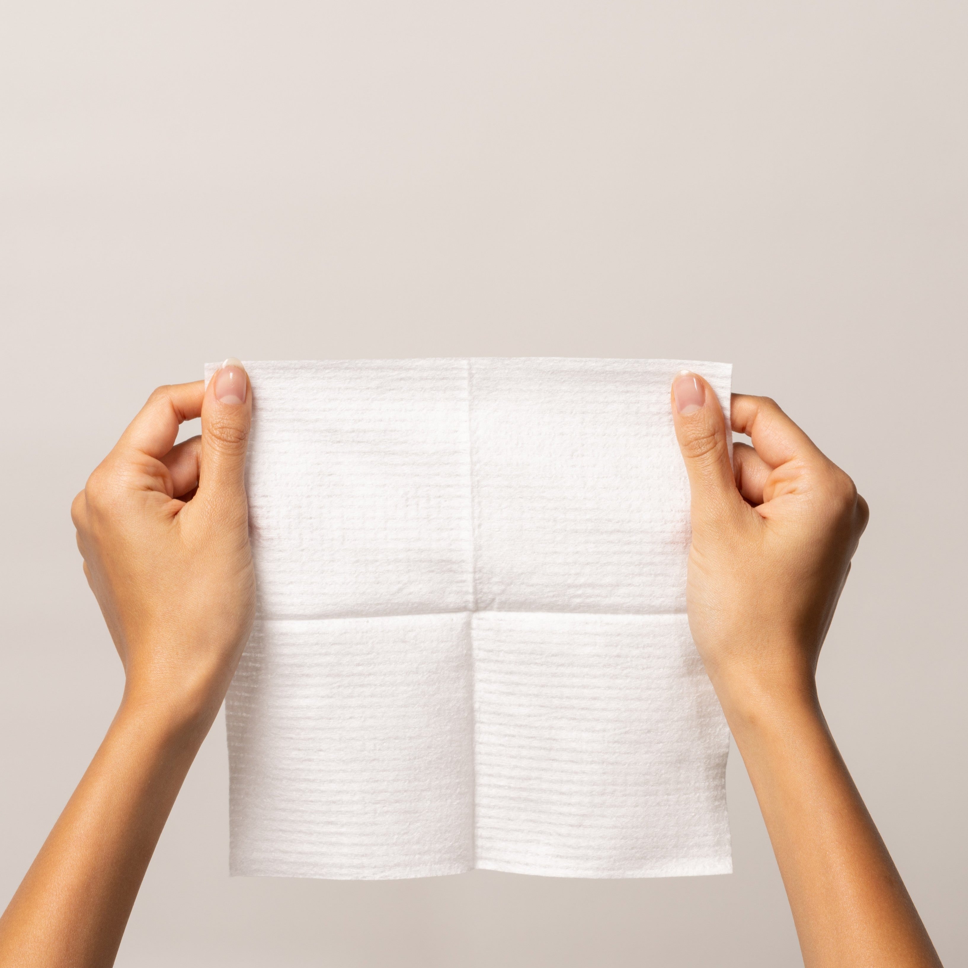 Kuwaiti hands holding a clean, single-use towel from the Travel Bundle by Bamteek.